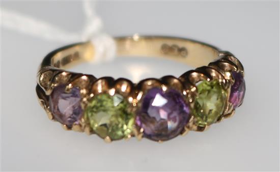 A 1970s 9ct gold and graduated five stone amethyst and peridot half hoop ring, size N.